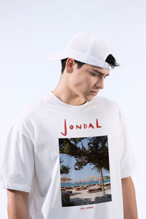 Person wearing a white t-shirt with a beach graphic and 'Jondal' branding.