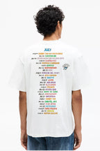 Person wearing a white t-shirt with colorful text on the back, standing against a white background